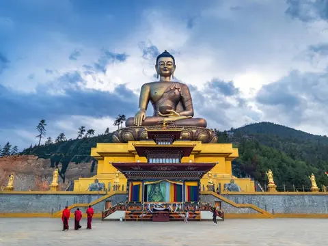 small_Ours._S._Buddha_dordenma_statue_with_monks_and_tourists_in_Thimphu__Bhutan