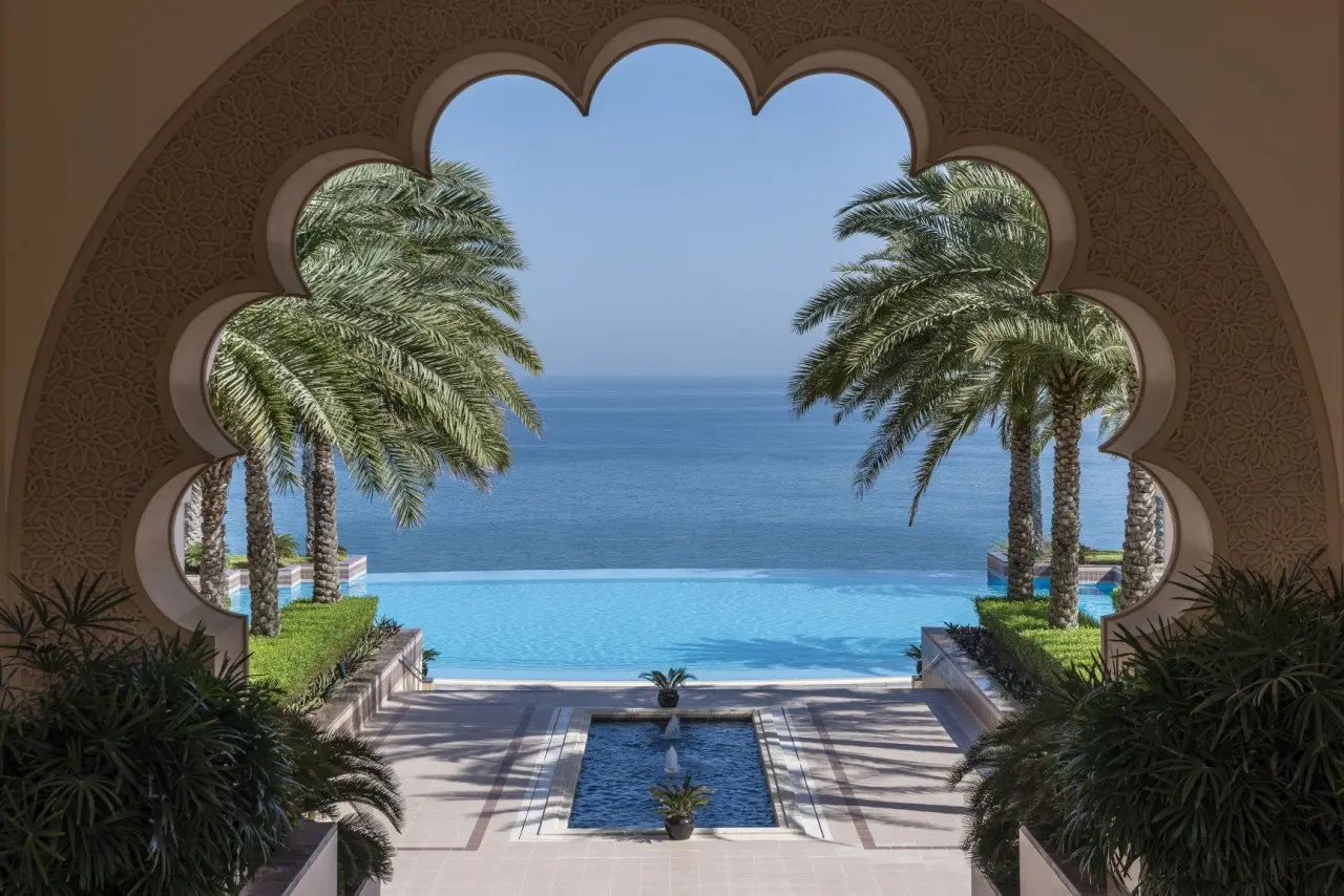 Al Husn pool through courtyard arch A