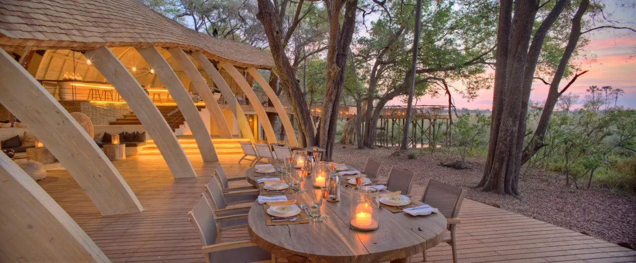 Botswana-Sandibe-Guest-Area-dinner-on-deck-at-sunset