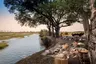 Botswana-Sandibe-Guest-delight-lunch-by-the-river-with-vehicle