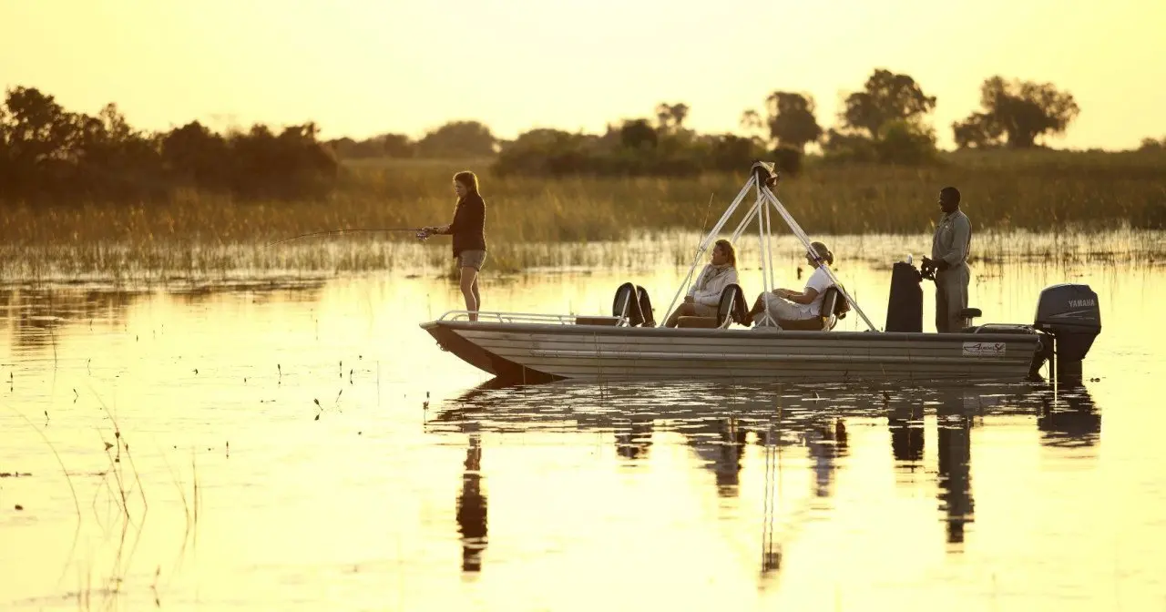 Botswana-Nxabega-Okavango-Delta-Camp-Exerience-Boat-cruise-fishing-at-sunset