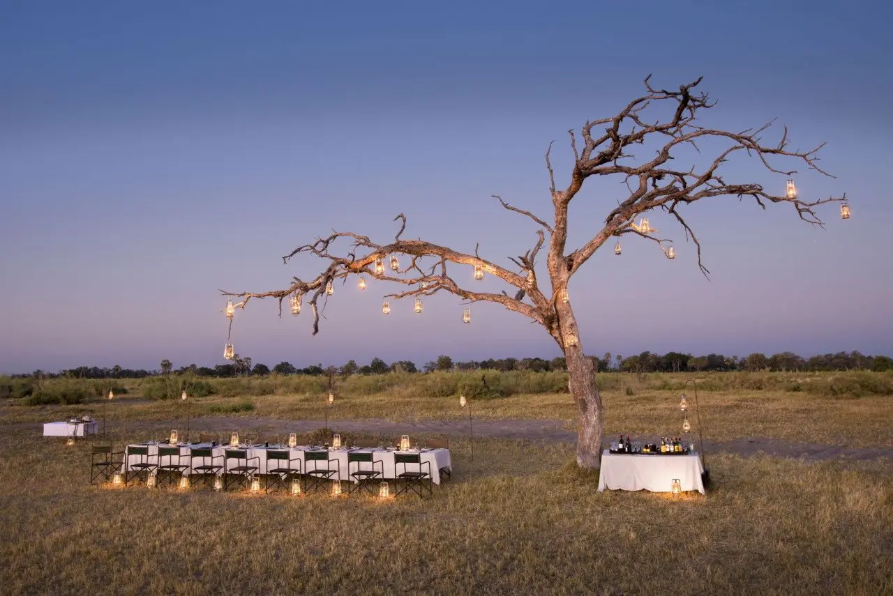 Botswana-Nxabega-Okavango-Tented-Camp-Guest-Delight-dinner-set-up-in-the-bush-at-sunset-without-people