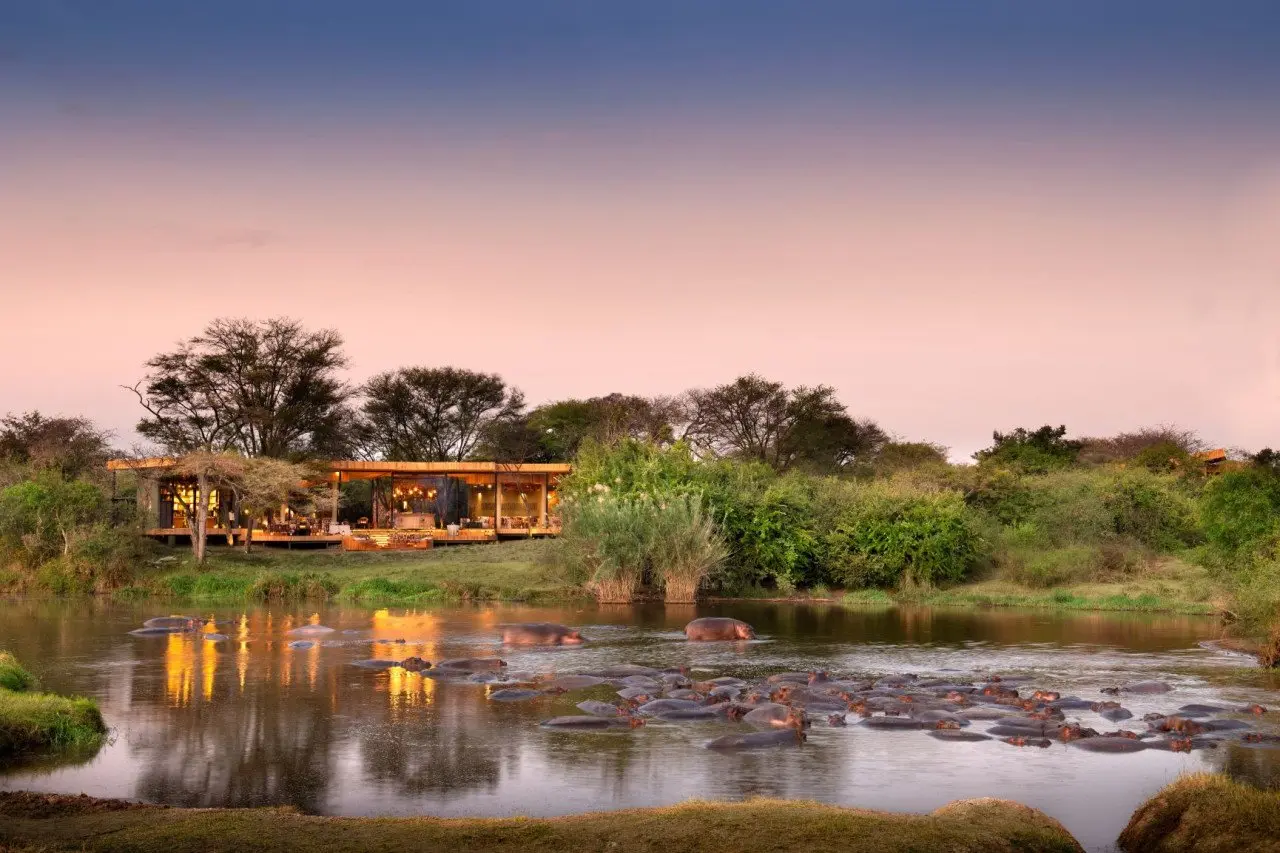 Tanzania-Grumeti-Serengeti-River-Lodge-Guest-Area-exterior-view-with-hippo-pod-in-river_4