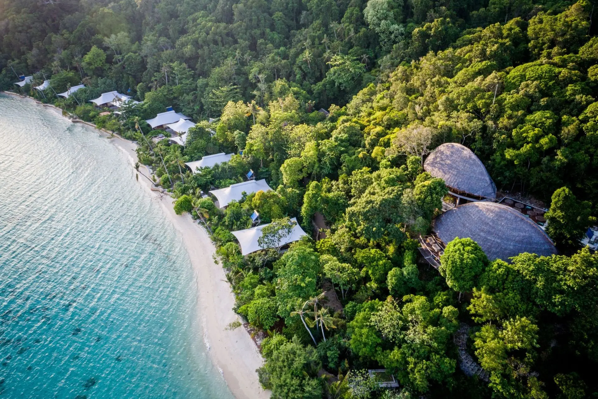 aerial_west_beach_suites_green_forest_background