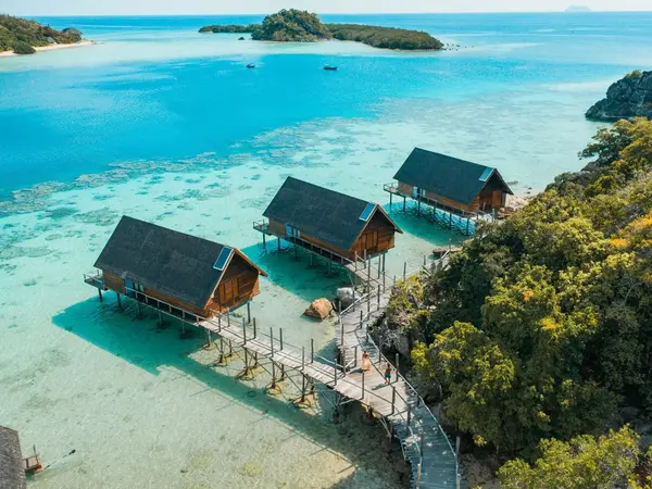 aerial_couple_walking_on_west_overwater_suites_pathway_with_lidi_view
